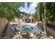 A private backyard pool with mature landscaping and stone accents at 7340 W Bronco Trl, Peoria, AZ 85383