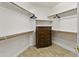 Large walk in closet with custom shelving and a chest of drawers at 7340 W Bronco Trl, Peoria, AZ 85383