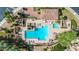 Top down aerial view of a community pool and jacuzzi, surrounded by lush landscaping and seating at 7955 E Chaparral Rd # 141, Scottsdale, AZ 85250