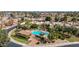 Stunning aerial view of a community pool surrounded by lush landscaping and beautiful homes with red tile roofs at 7955 E Chaparral Rd # 141, Scottsdale, AZ 85250