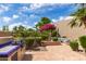 Serene backyard featuring a built-in BBQ, lush landscaping, and cozy seating area at 7955 E Chaparral Rd # 141, Scottsdale, AZ 85250