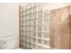 Bathroom featuring toilet, glass block shower and tile at 7955 E Chaparral Rd # 141, Scottsdale, AZ 85250