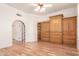 Bedroom boasts hardwood floors and custom built-in cabinetry for ample storage at 7955 E Chaparral Rd # 141, Scottsdale, AZ 85250