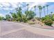 Elegant community entrance with lush landscaping and desert flora at 7955 E Chaparral Rd # 141, Scottsdale, AZ 85250