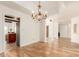 Inviting dining area featuring hardwood floors, a classic chandelier, and open access to the kitchen at 7955 E Chaparral Rd # 141, Scottsdale, AZ 85250