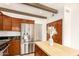 Well-equipped kitchen boasting stainless steel appliances, wood cabinets, tile floors, and a kitchen island at 7955 E Chaparral Rd # 141, Scottsdale, AZ 85250