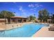 Community pool with a covered cabana and lounge chairs offers a perfect spot for relaxation and recreation at 7955 E Chaparral Rd # 141, Scottsdale, AZ 85250