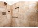 Detail of the tile shower with built-in niche and safety bar at 7955 E Chaparral Rd # 141, Scottsdale, AZ 85250