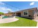 Inviting backyard featuring a pool, patio space, artificial turf, and string lights at 8010 W Atlantis Way, Phoenix, AZ 85043