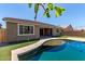Charming backyard featuring a refreshing pool and an outdoor living space perfect for entertaining at 8010 W Atlantis Way, Phoenix, AZ 85043