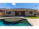 Inviting backyard oasis featuring a private pool, lush turf, and seamless indoor-outdoor living at 8010 W Atlantis Way, Phoenix, AZ 85043