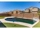 Private backyard featuring a sparkling pool, manicured turf, and privacy fence, perfect for relaxation at 8010 W Atlantis Way, Phoenix, AZ 85043