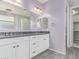 A bathroom featuring a double vanity with white cabinets, gray countertops, and tile flooring at 8010 W Atlantis Way, Phoenix, AZ 85043