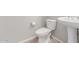 Powder bath with pedestal sink and wood-look tile flooring at 8010 W Atlantis Way, Phoenix, AZ 85043