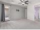 A bedroom with carpet and gray walls, and a door that leads to a balcony at 8010 W Atlantis Way, Phoenix, AZ 85043