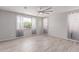 Bright bedroom featuring wood-look tile floors, large windows, and neutral paint at 8010 W Atlantis Way, Phoenix, AZ 85043