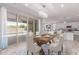 Dining room features a modern chandelier, wood table and chairs, and sliding door access to outdoor pool at 8010 W Atlantis Way, Phoenix, AZ 85043
