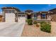 Charming single-story home with a well-manicured front yard, stone accents, and a three-car garage at 8010 W Atlantis Way, Phoenix, AZ 85043