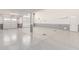 Spacious garage with epoxy flooring, neutral walls, and garage doors at 8010 W Atlantis Way, Phoenix, AZ 85043