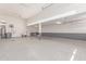 Large garage with gray epoxy floors and a utility sink on the back wall at 8010 W Atlantis Way, Phoenix, AZ 85043