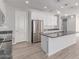 Bright, modern kitchen with stainless steel appliances, granite countertops, and white cabinetry at 8010 W Atlantis Way, Phoenix, AZ 85043