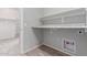 Laundry room with gray walls, wooden floor, and built-in shelves at 8010 W Atlantis Way, Phoenix, AZ 85043