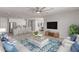 Open-concept living room with modern furnishings, ceiling fan, and seamless transition to the kitchen and dining area at 8010 W Atlantis Way, Phoenix, AZ 85043