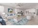 Inviting living room featuring a comfortable seating area, stylish decor, and seamless flow to kitchen at 8010 W Atlantis Way, Phoenix, AZ 85043