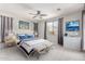 Relaxing main bedroom with neutral tones, plush bedding, window and ensuite bath at 8010 W Atlantis Way, Phoenix, AZ 85043