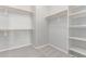 A walk-in closet with shelving on the right and hanging racks on the left at 8010 W Atlantis Way, Phoenix, AZ 85043