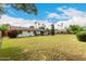 Expansive backyard featuring a lush lawn, mature trees, and a covered patio, perfect for relaxation at 8121 N 8Th Ave, Phoenix, AZ 85021
