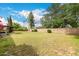 Green backyard features a lawn, patio, lush landscaping and mature trees at 8121 N 8Th Ave, Phoenix, AZ 85021