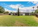 Spacious backyard with lush lawn, covered patio, and mature trees at 8121 N 8Th Ave, Phoenix, AZ 85021