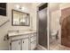 Bathroom featuring a single sink vanity, shower, and a large mirror at 8121 N 8Th Ave, Phoenix, AZ 85021