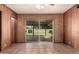 Bedroom with wood-paneled walls and sliding glass doors leading to the backyard patio at 8121 N 8Th Ave, Phoenix, AZ 85021