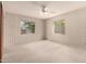 Spacious bedroom with a ceiling fan, two windows, and neutral wallpaper at 8121 N 8Th Ave, Phoenix, AZ 85021