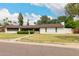 Charming single-story home with a well-manicured lawn and mature trees enhancing curb appeal at 8121 N 8Th Ave, Phoenix, AZ 85021