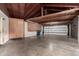 Unfinished garage featuring cabinets, work bench and a garage door at 8121 N 8Th Ave, Phoenix, AZ 85021