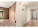Hallway featuring a sliding glass door, tile floors, and paneling at 8121 N 8Th Ave, Phoenix, AZ 85021