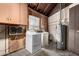 Laundry room area with washer, dryer, water heater, and overhead storage at 8121 N 8Th Ave, Phoenix, AZ 85021