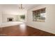 Spacious living room with hardwood floors, a fireplace, and large windows offering a pleasant view at 8121 N 8Th Ave, Phoenix, AZ 85021