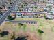 Aerial view of a home with a refreshing pool, solar panels for energy efficiency, and a well-kept lawn in a residential area at 821 E Harmony Ave, Mesa, AZ 85204