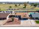 A high angle shows the house and backyard, the proximity to community park space, a swimming pool, and solar panels at 821 E Harmony Ave, Mesa, AZ 85204