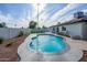 Inviting backyard pool with a patio, lush landscaping, and a white brick privacy fence at 821 E Harmony Ave, Mesa, AZ 85204