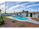 Lush backyard featuring a pool, ample sunlight, desert landscaping, and a patio area for outdoor enjoyment at 821 E Harmony Ave, Mesa, AZ 85204