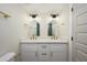 Modern bathroom with double sink vanity, gold hardware, and new mirrors at 821 E Harmony Ave, Mesa, AZ 85204