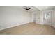 Bright bedroom with new floors, a modern ceiling fan, and a doorway to another room at 821 E Harmony Ave, Mesa, AZ 85204