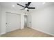 Bright bedroom with new flooring and a ceiling fan with sliding door closet and hall access at 821 E Harmony Ave, Mesa, AZ 85204