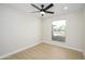 Bright bedroom with new flooring, a ceiling fan, and a window with a view of desert landscaping at 821 E Harmony Ave, Mesa, AZ 85204
