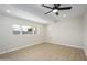 Bright bedroom featuring a ceiling fan, light hardwood floors and a window with natural light at 821 E Harmony Ave, Mesa, AZ 85204